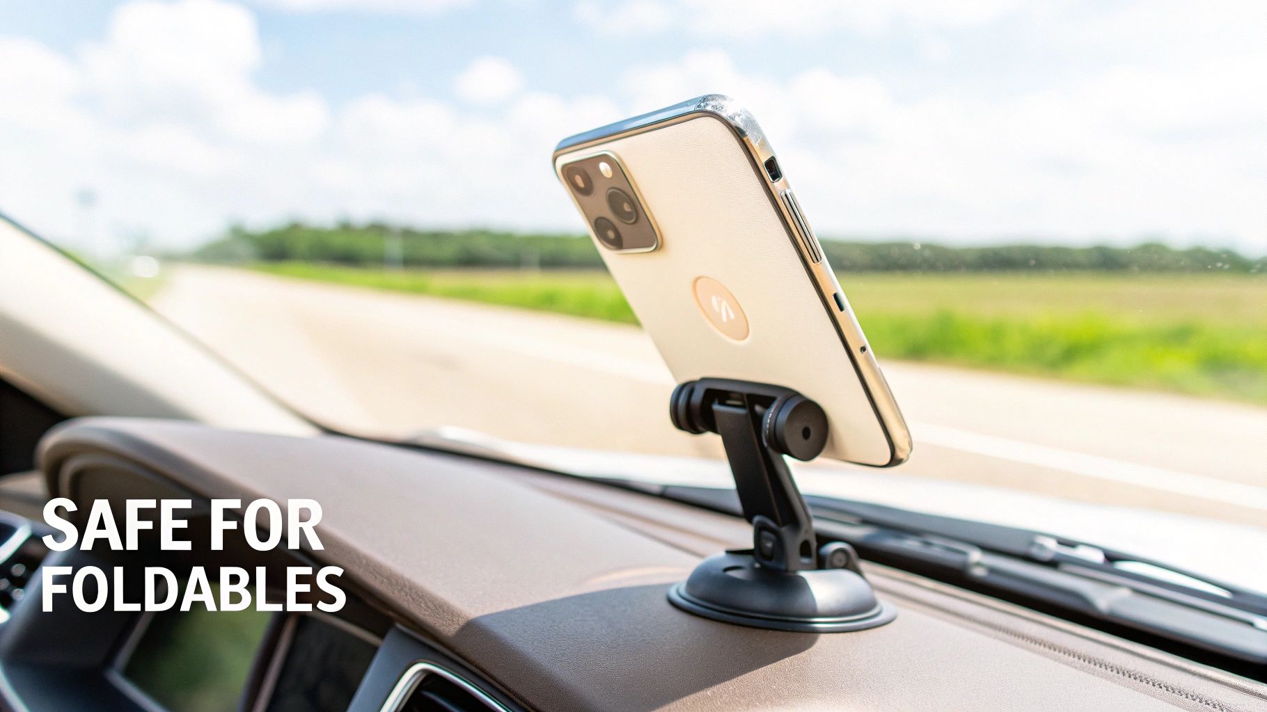 A smartphone securely held by a suction cup mount on a car's dashboard, with a blurry road in the background.