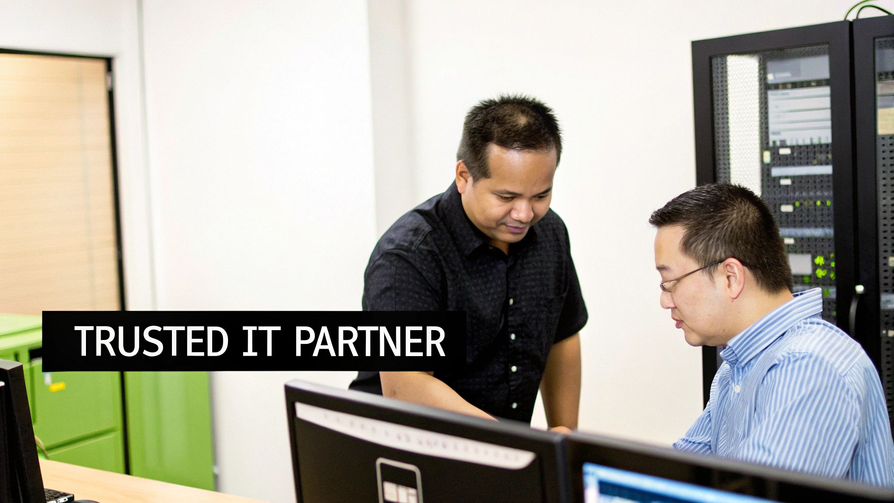 An IT professional from Klimka Computer Solutions assisting a client in a Hamilton office setting