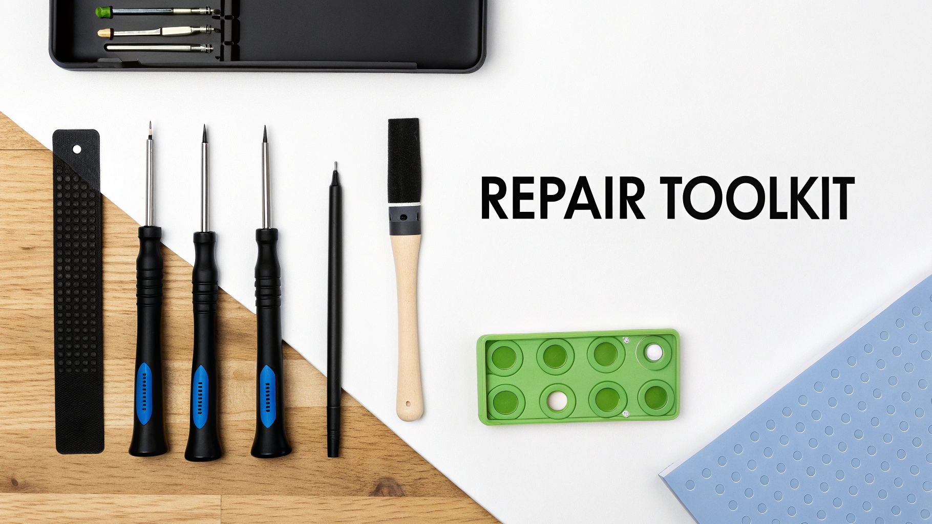 A set of specialized tools for electronic repair laid out on a clean work surface.
