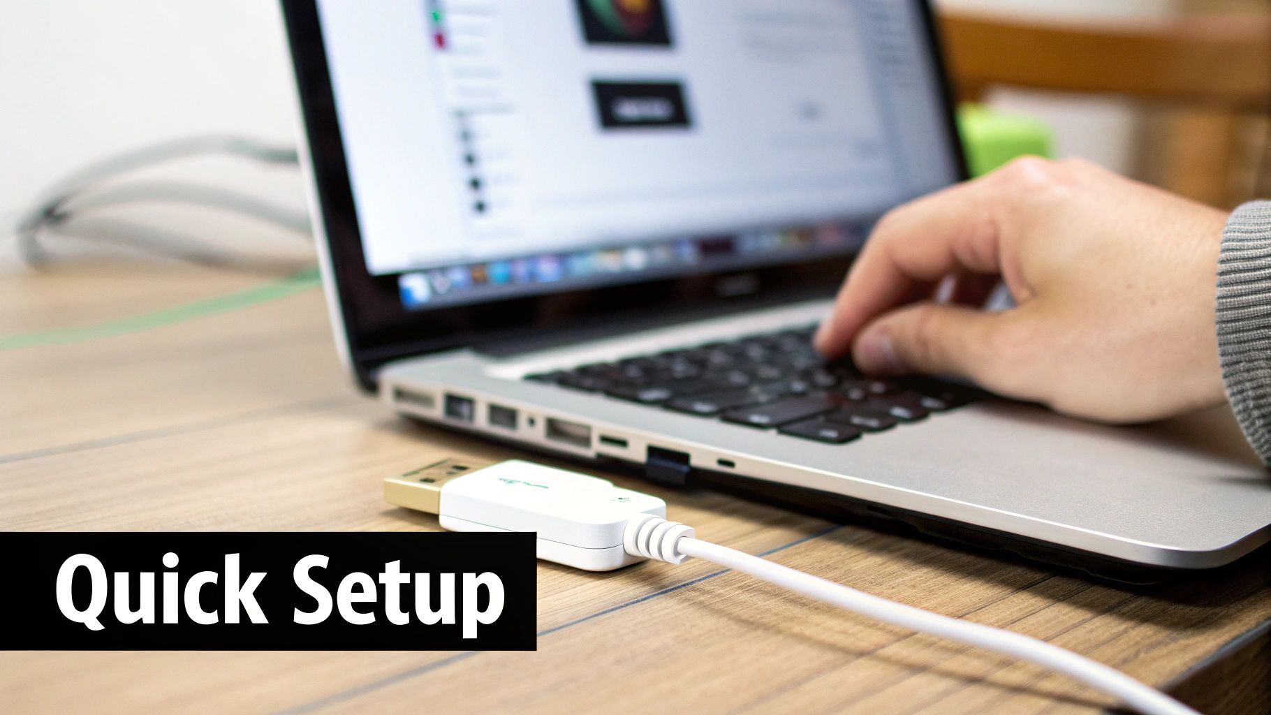 A person types on a silver laptop, with a white Ethernet to USB adapter plugged in, showing a quick setup.