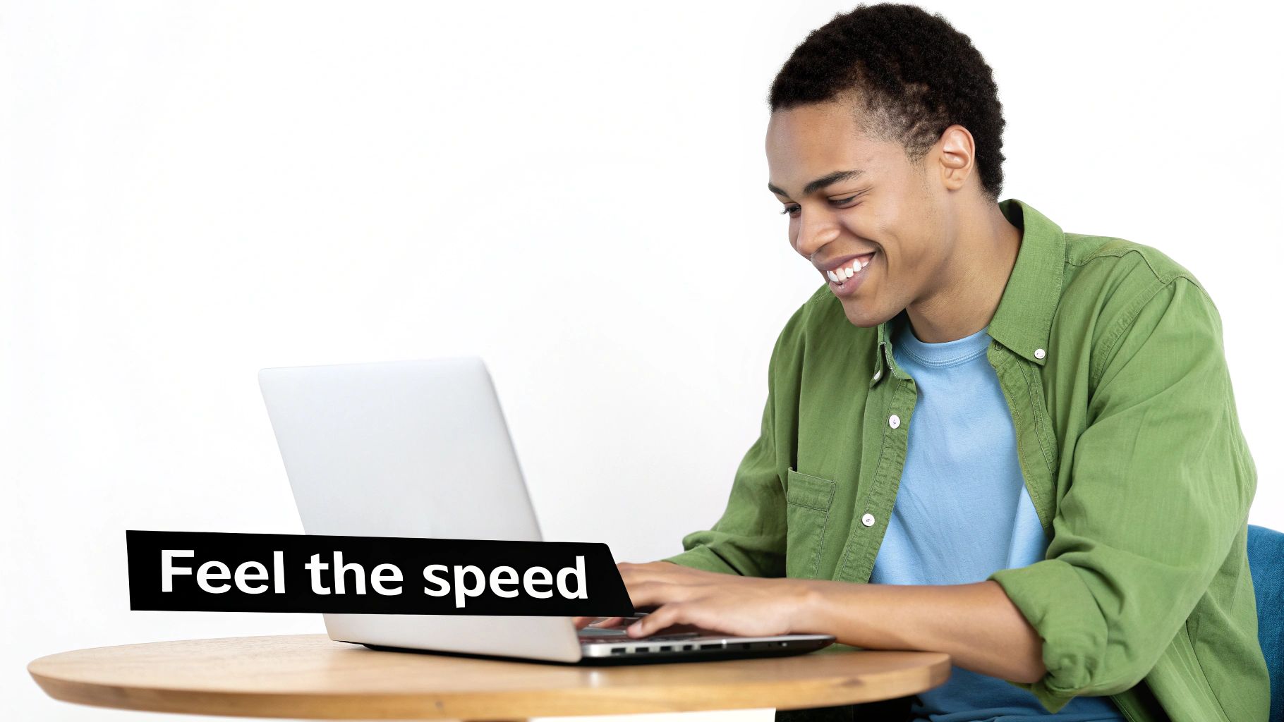 A smiling young man works on a laptop at a wooden table with 'Feel the speed' overlay.