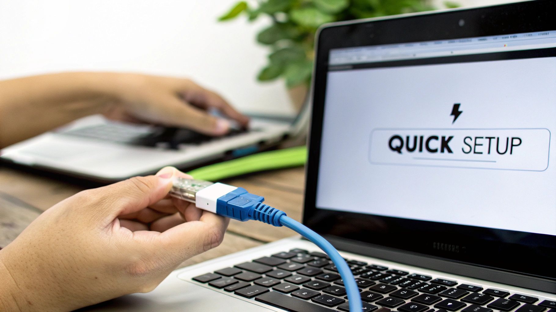 Close-up of hands plugging an Ethernet adapter into a laptop displaying 'Quick Setup'.