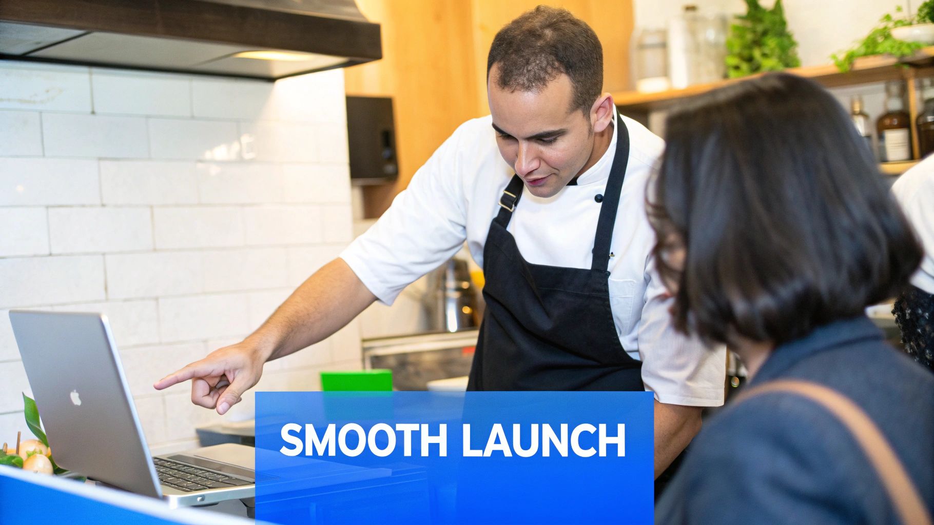 A team of restaurant staff gathered around a tablet, learning a new system.
