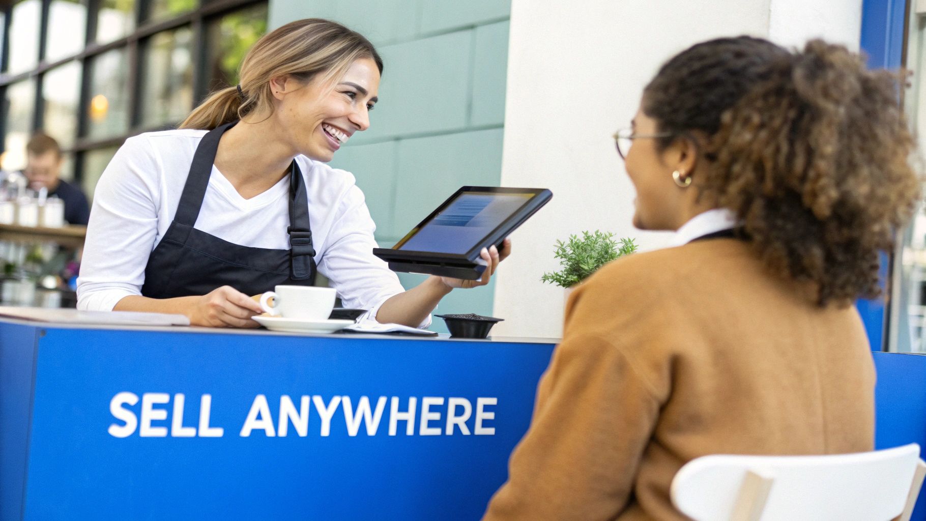 A person using a tablet POS system to take a payment from a customer.