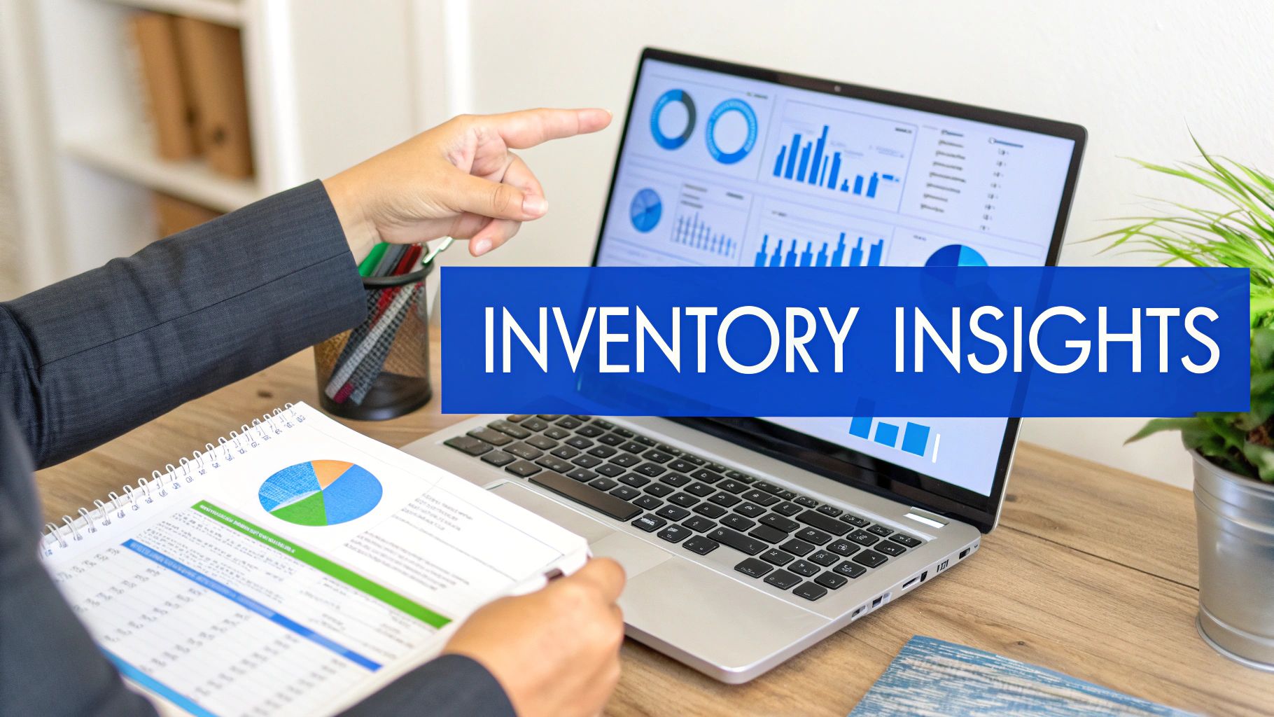 A person points at a laptop screen showing inventory charts while holding a report.