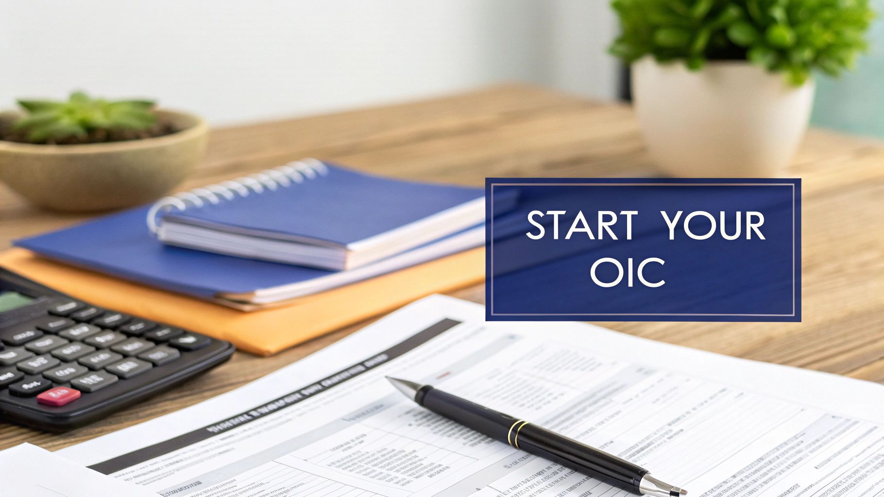 Desk with financial forms, calculator, notebooks, and a sign that reads 'START YOUR OIC'.