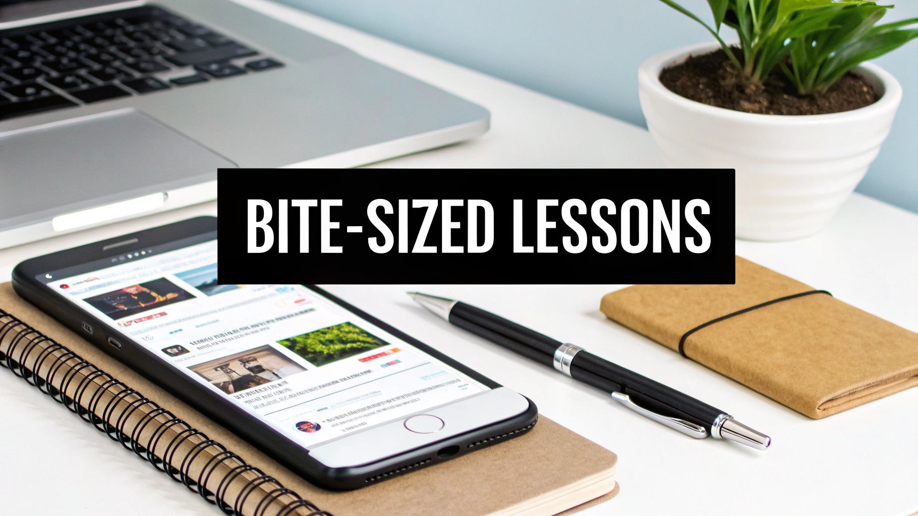 A desk with a laptop, smartphone displaying online content, pen, notebook, and a plant, with 'BITE-SIZED LESSONS' text.