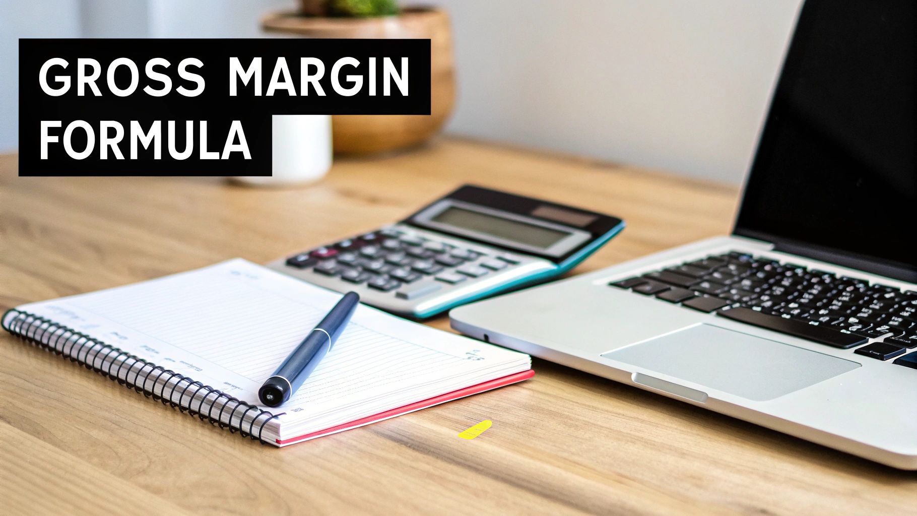 Gross margin formula text over desk with laptop, calculator, pen, and notebook.
