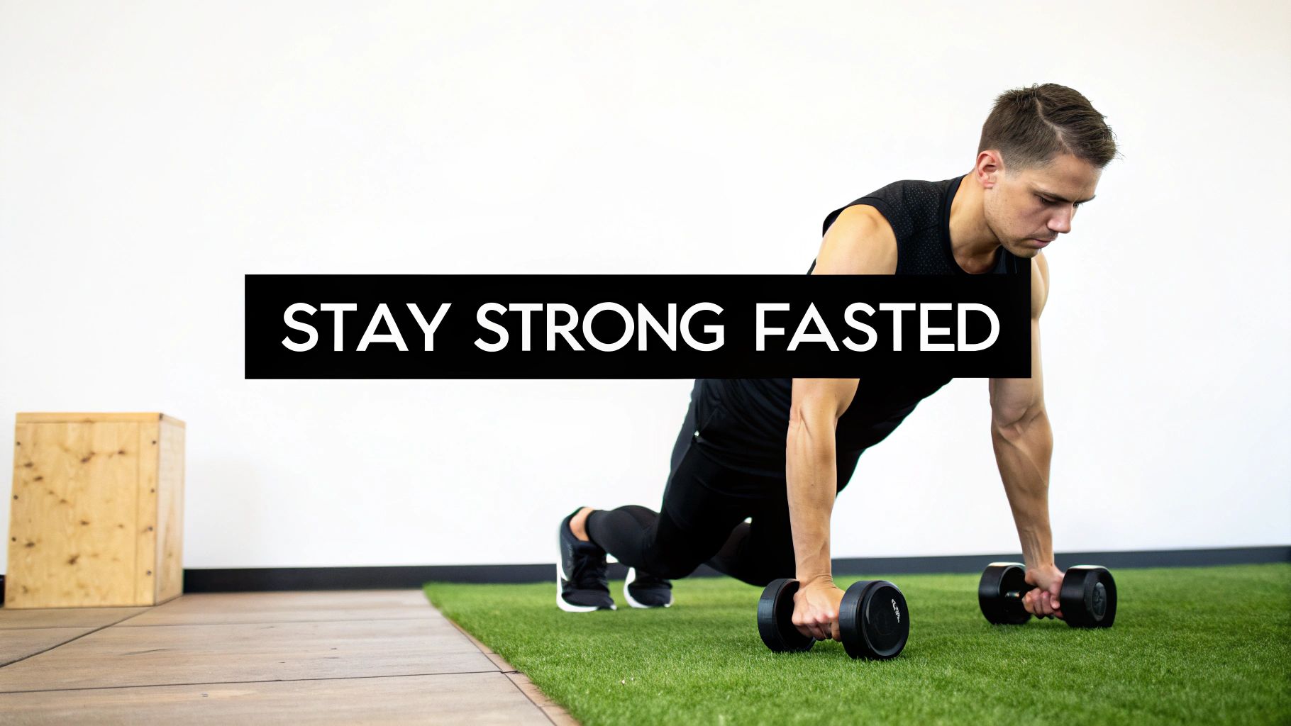 A man performing a dumbbell exercise on a gym floor with turf, featuring 'STAY STRONG FASTED' text.
