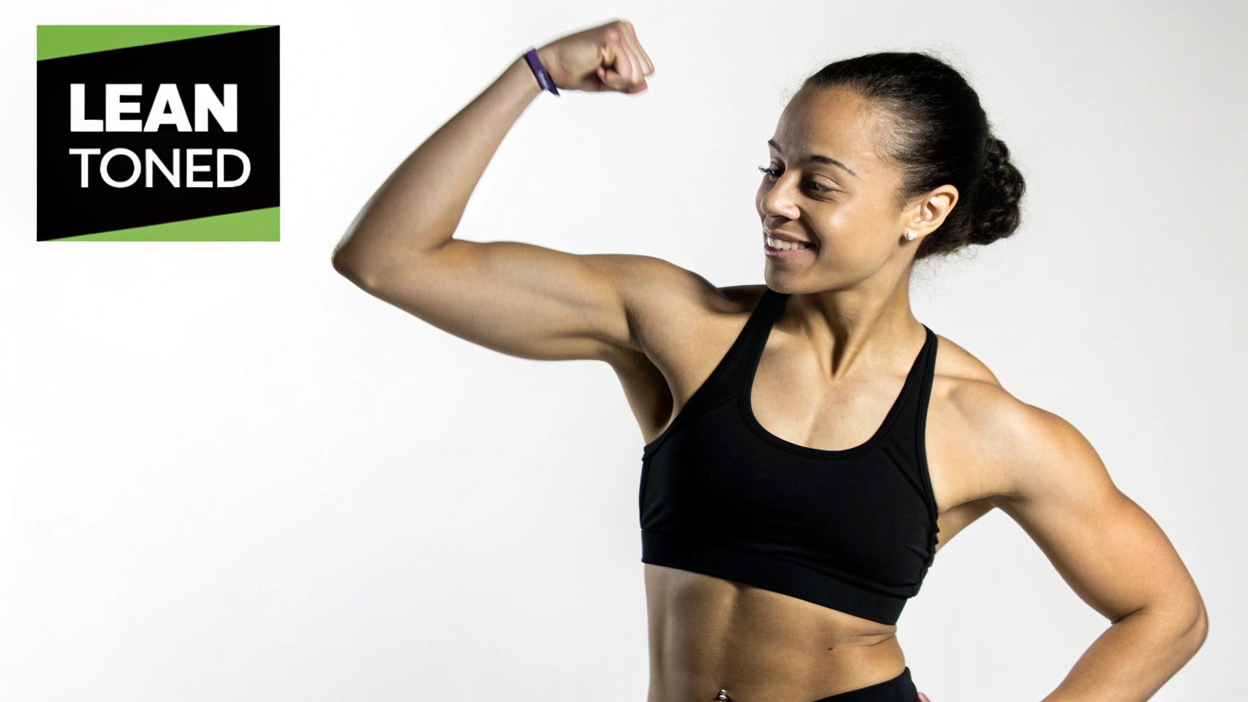 A fit woman in athletic wear, posing to show her toned physique, conveying strength and confidence.