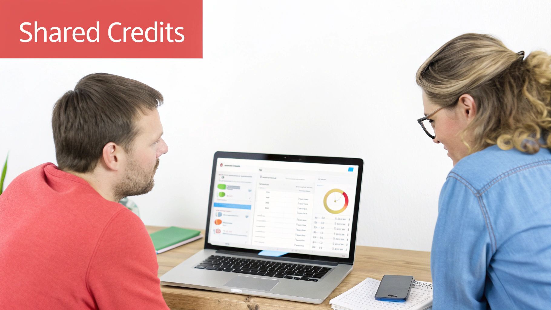 Man and woman review 'Shared Credits' data on a laptop, discussing financial information.