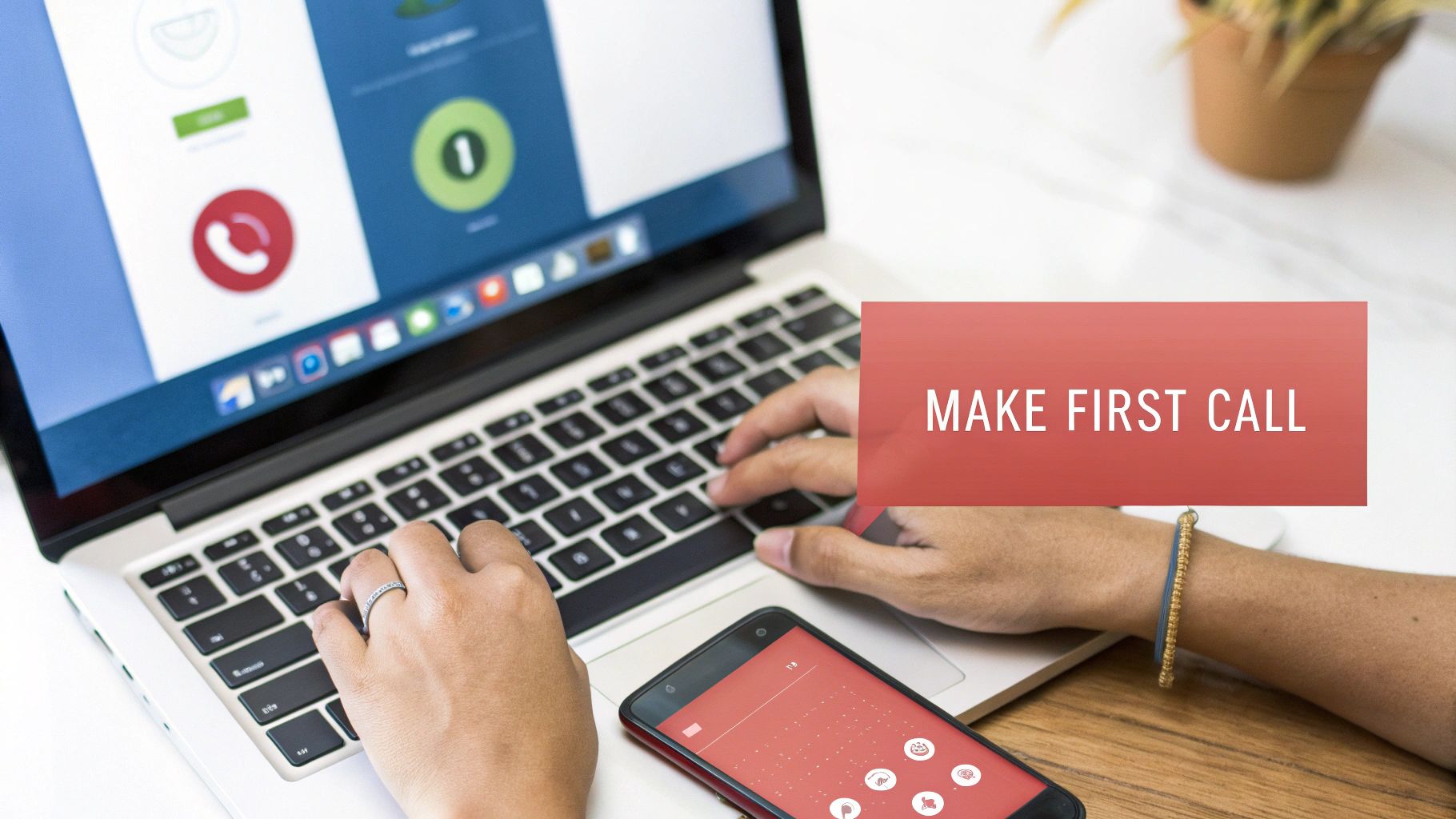 Person typing on a laptop with a smartphone nearby, showing a 'MAKE FIRST CALL' overlay on a screen.