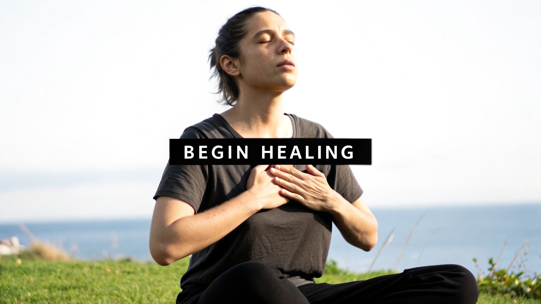 A person with closed eyes and hands on their chest, meditating outdoors, with text 'BEGIN HEALING'.