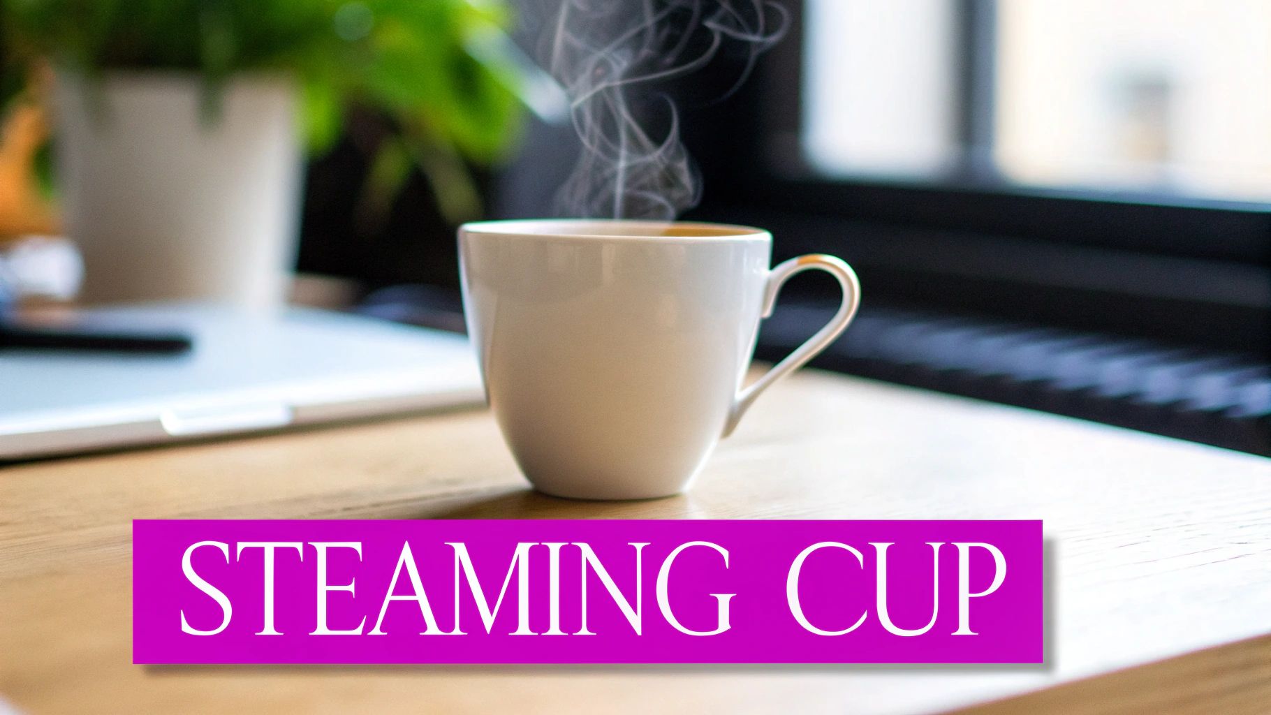 A steaming white cup on a wooden table with a blurred laptop and plant in the background.