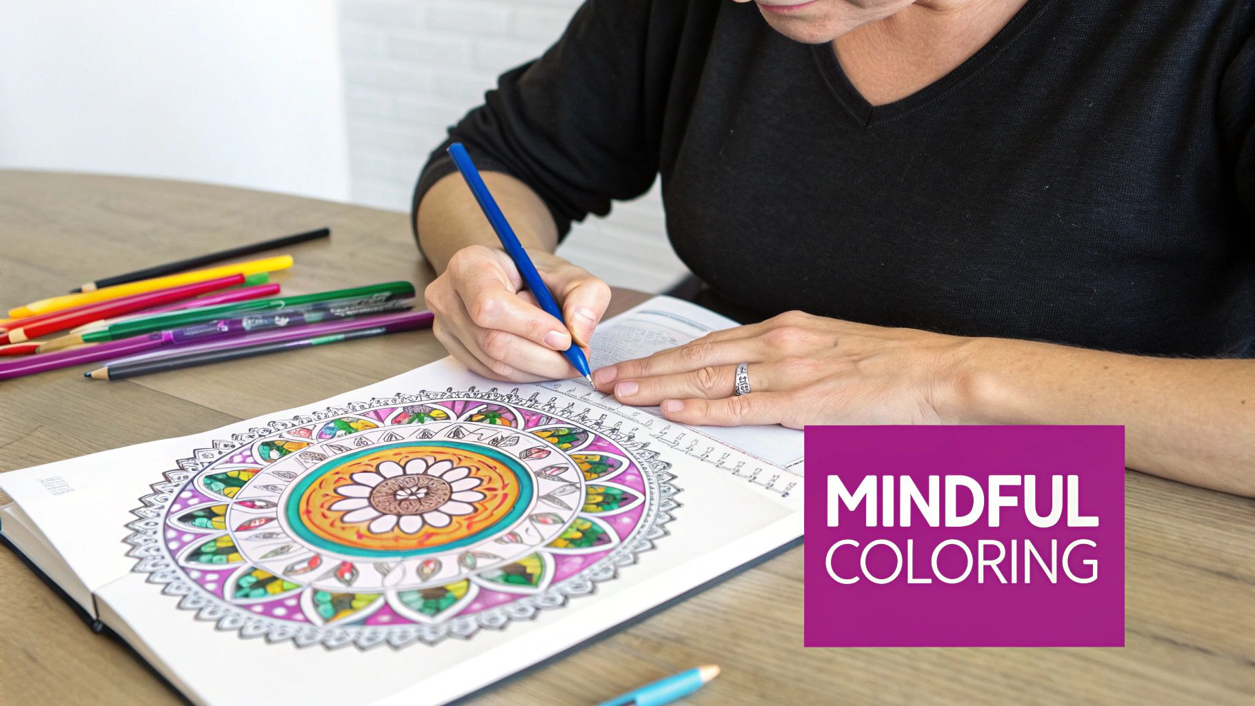 A woman peacefully coloring in a therapeutic coloring page with colored pencils.