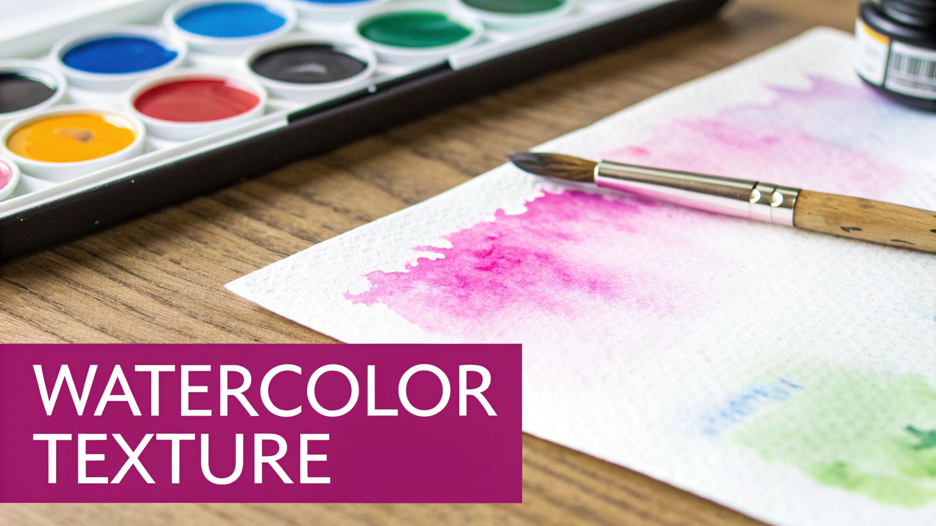 A watercolor paint set, a brush, and painted paper with vibrant pink, blue, and green strokes.