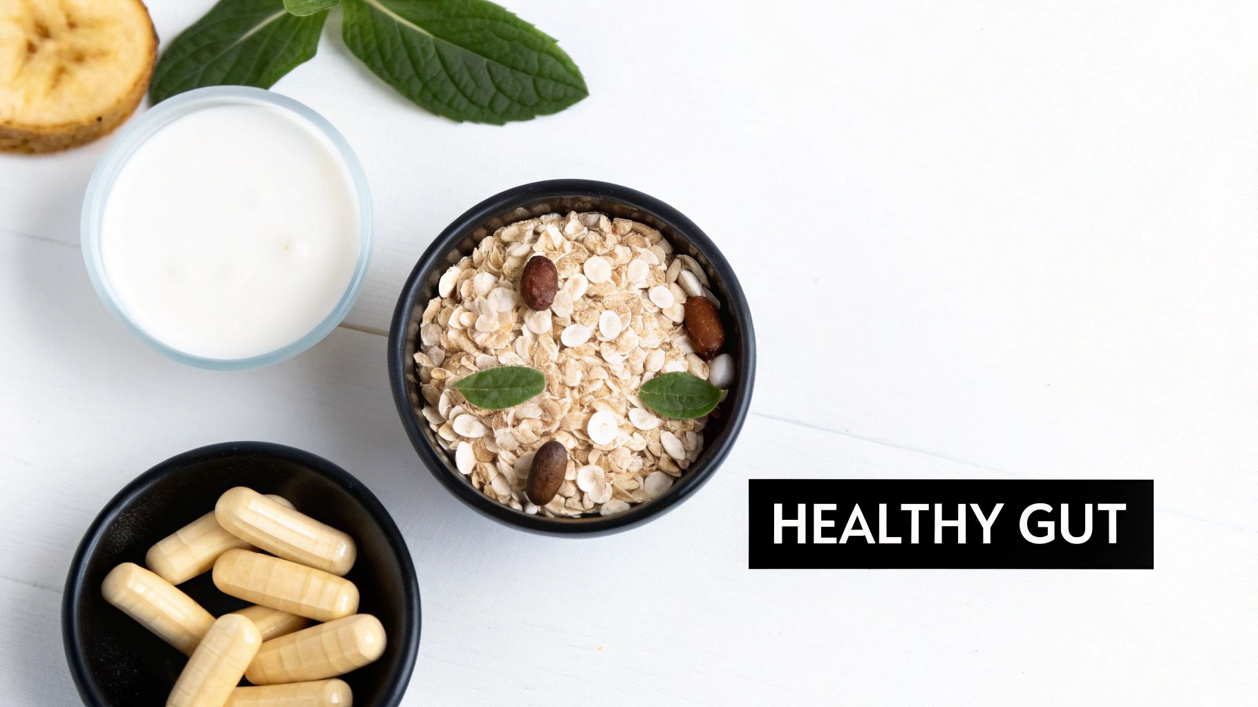 Overhead view of a healthy breakfast with oatmeal, yogurt, banana, and probiotic capsules for gut health.