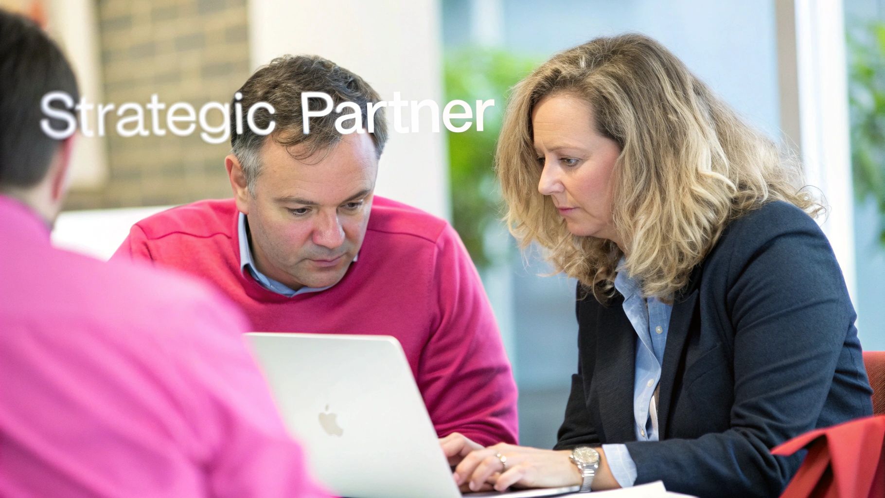 Man And Woman Intently Working On A Laptop, Symbolizing A Strategic Business Partnership.