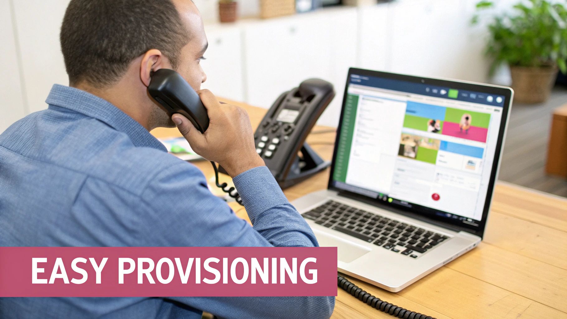 A Man Talks On A Desk Phone, Looking At A Laptop Displaying A Business Dashboard And 'Easy Provisioning'.
