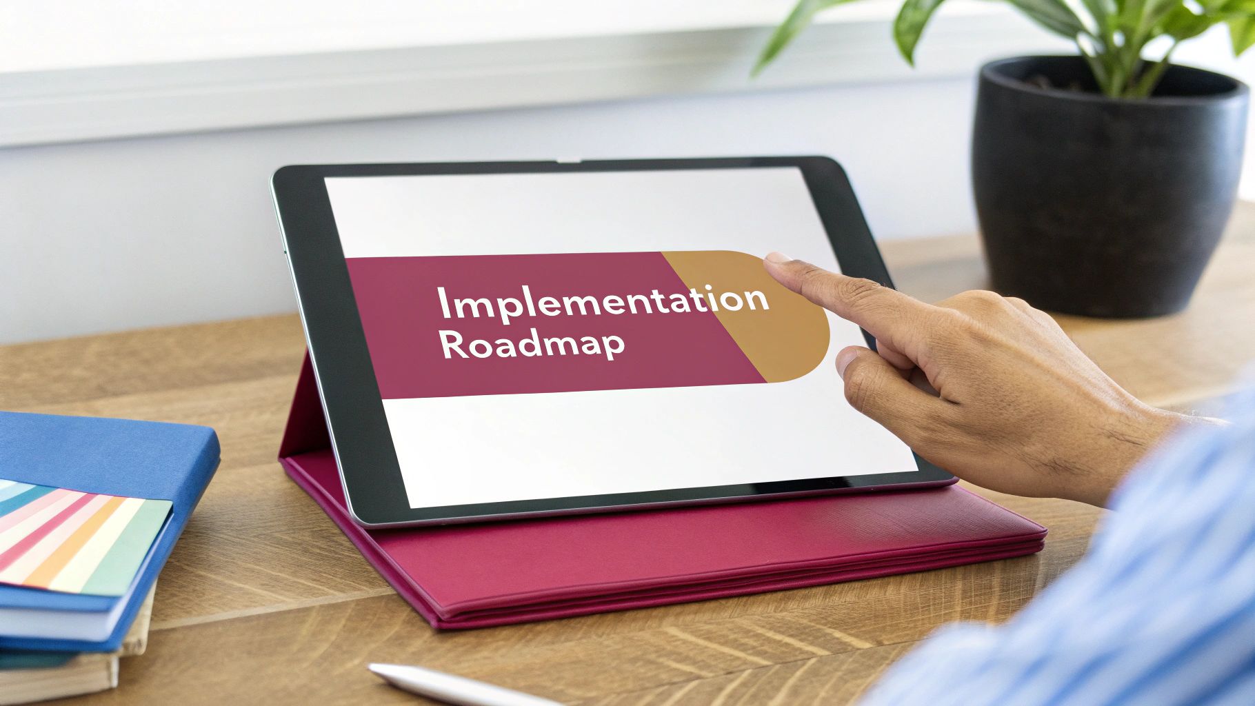 A Person'S Hand Interacts With A Tablet Displaying An 'Implementation Roadmap' On A Wooden Desk.
