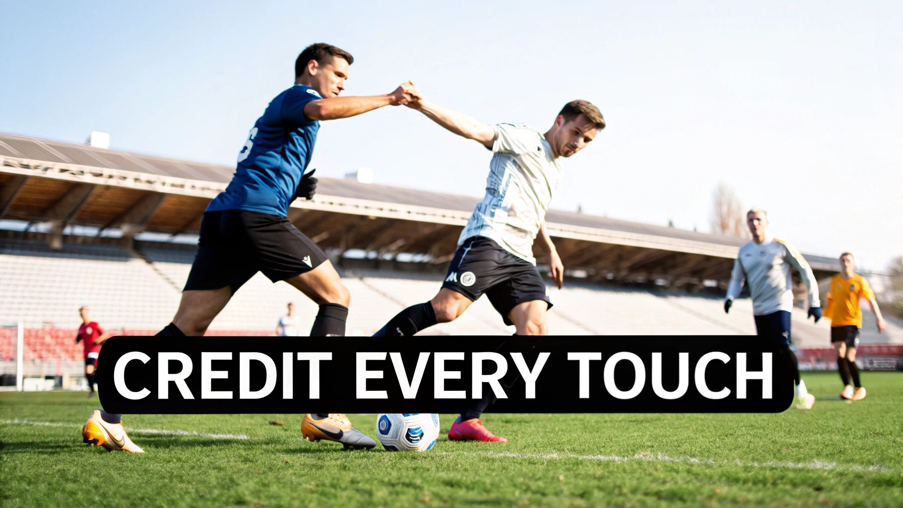 Two soccer players in uniforms compete for the ball on a sunny field during a match.
