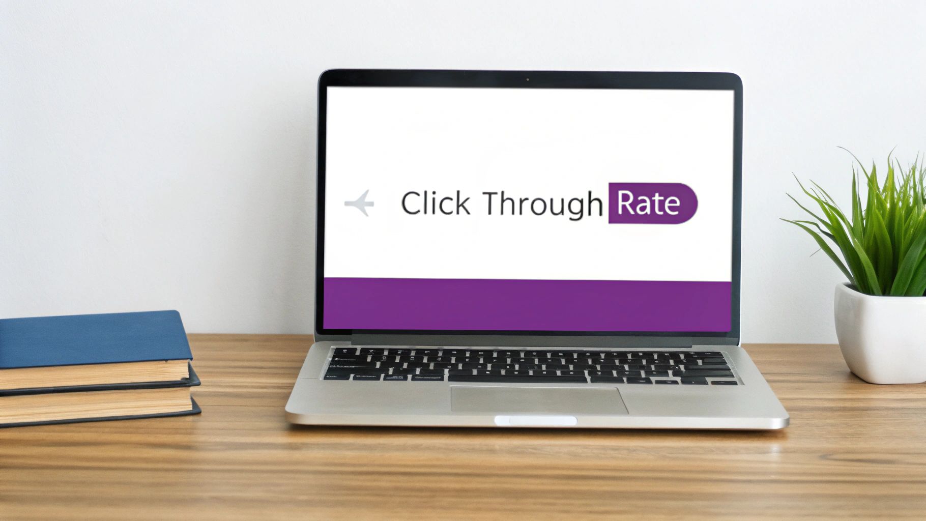 Laptop displaying 'Click Through Rate' on screen, surrounded by books and a potted plant.