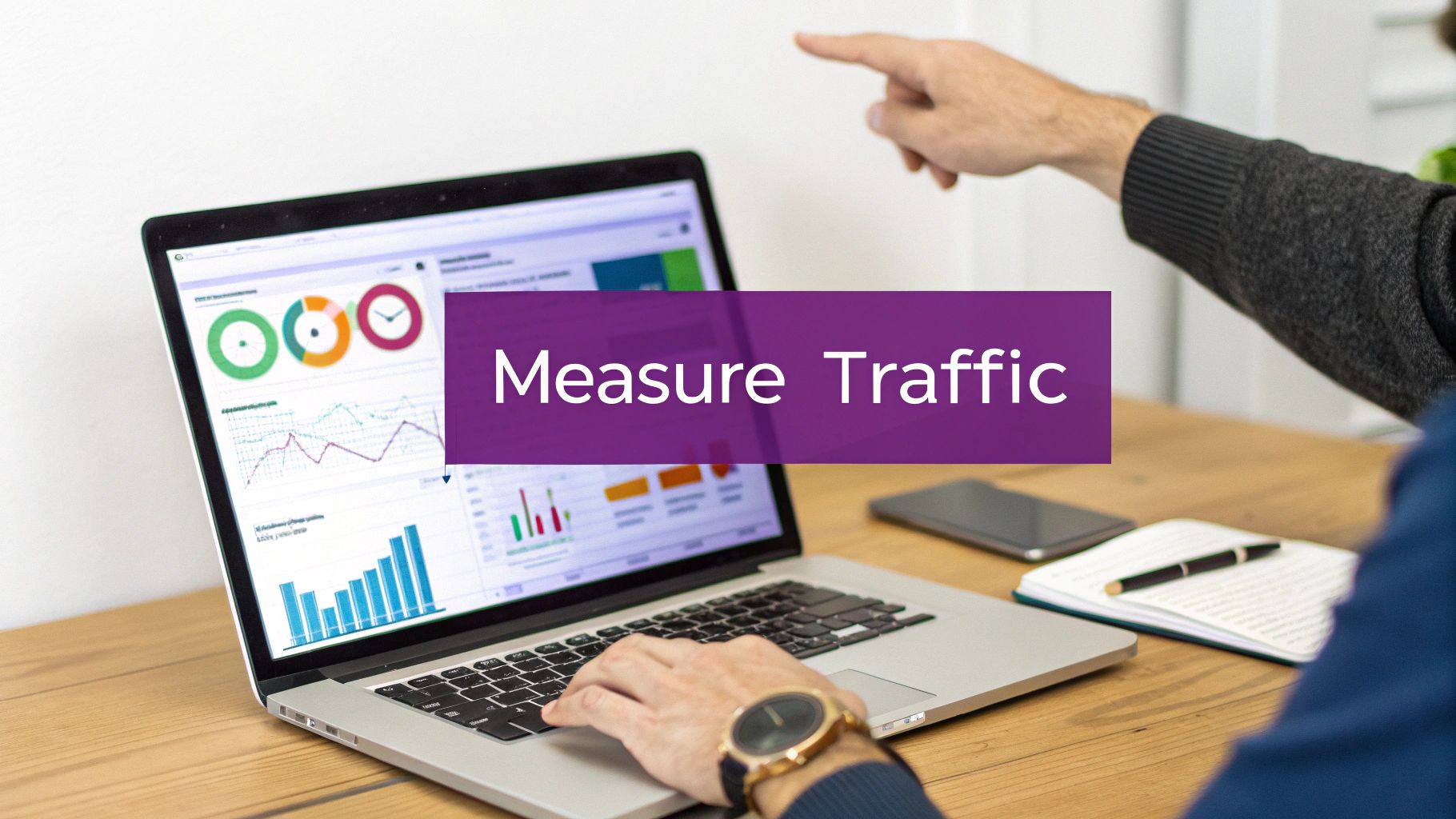 Two people collaboratively analyzing website traffic data and performance metrics on a laptop screen.