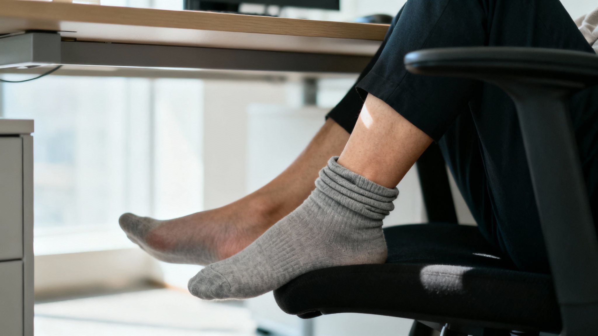 A person's legs with visible signs of poor circulation, such as swelling or discoloration.