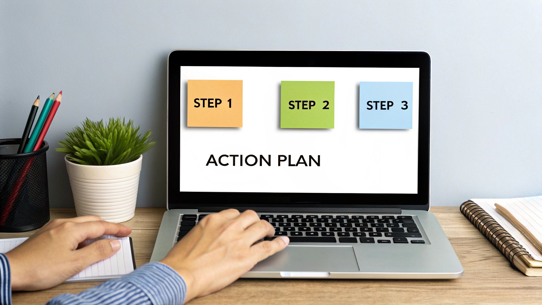 A person's hands typing on a laptop, indicating planning and action.