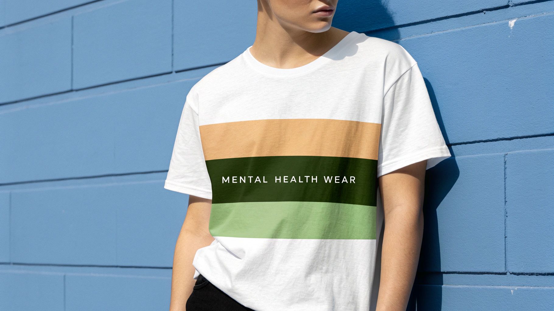 A person wearing a hoodie with a positive mental health message, sitting thoughtfully