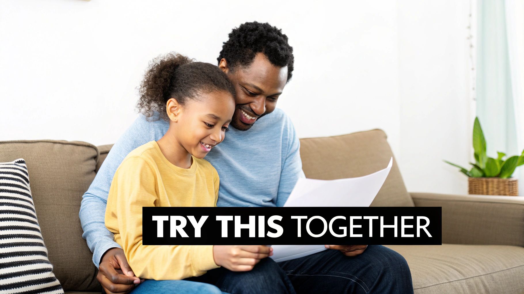 A child and an adult working together on a worksheet at a wooden table, smiling.