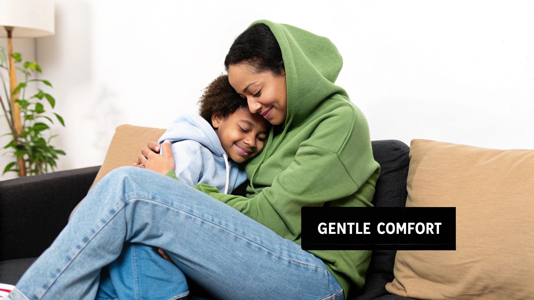 A loving mother and child embrace on a couch, both in cozy hoodies, sharing gentle comfort.