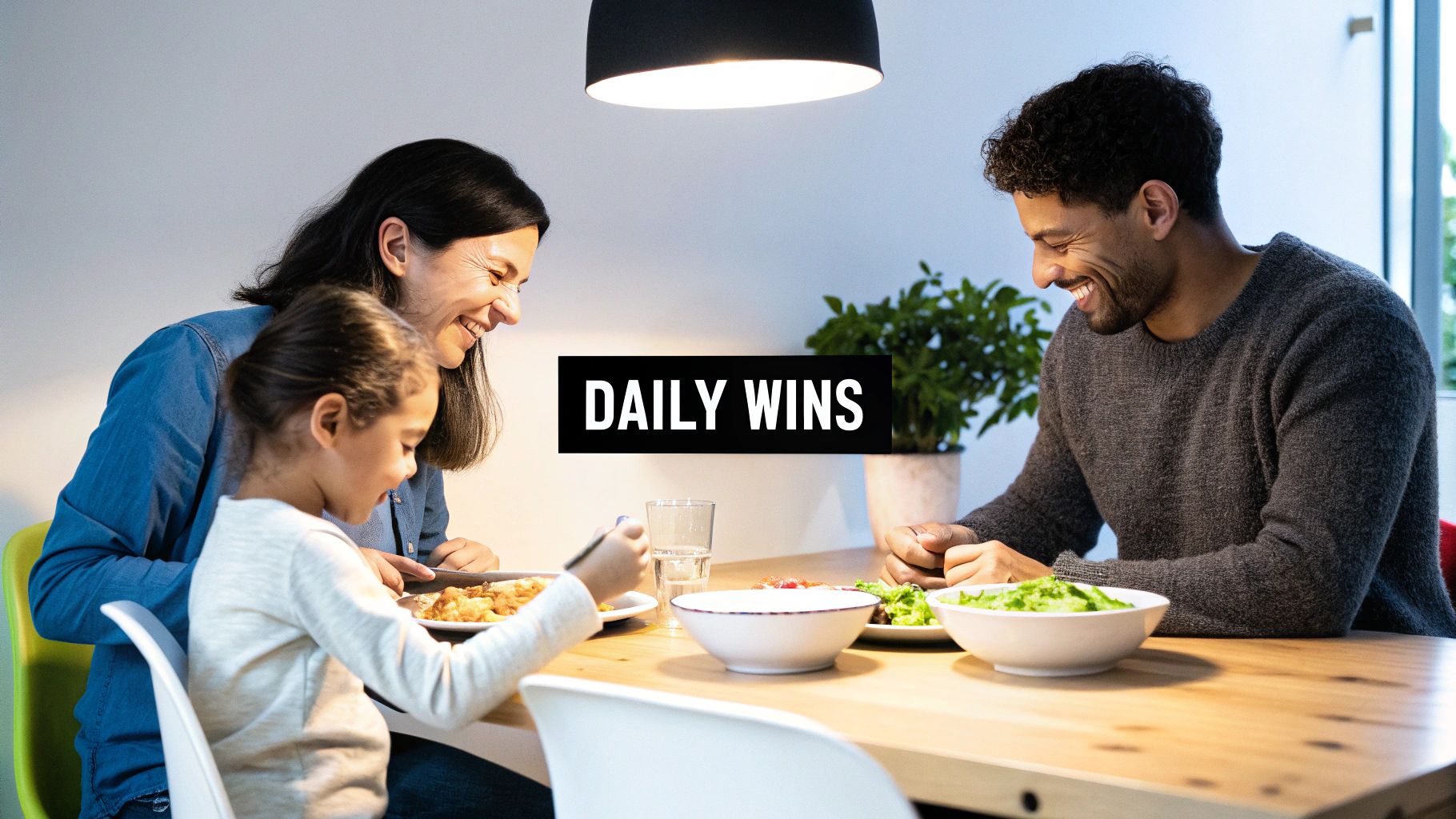 A parent and child looking at a worksheet together at a table, smiling.