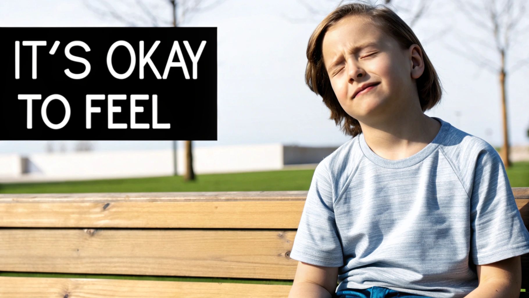 A young boy with closed eyes sits on a bench, feeling the sun, next to 'IT'S OKAY TO FEEL' text.