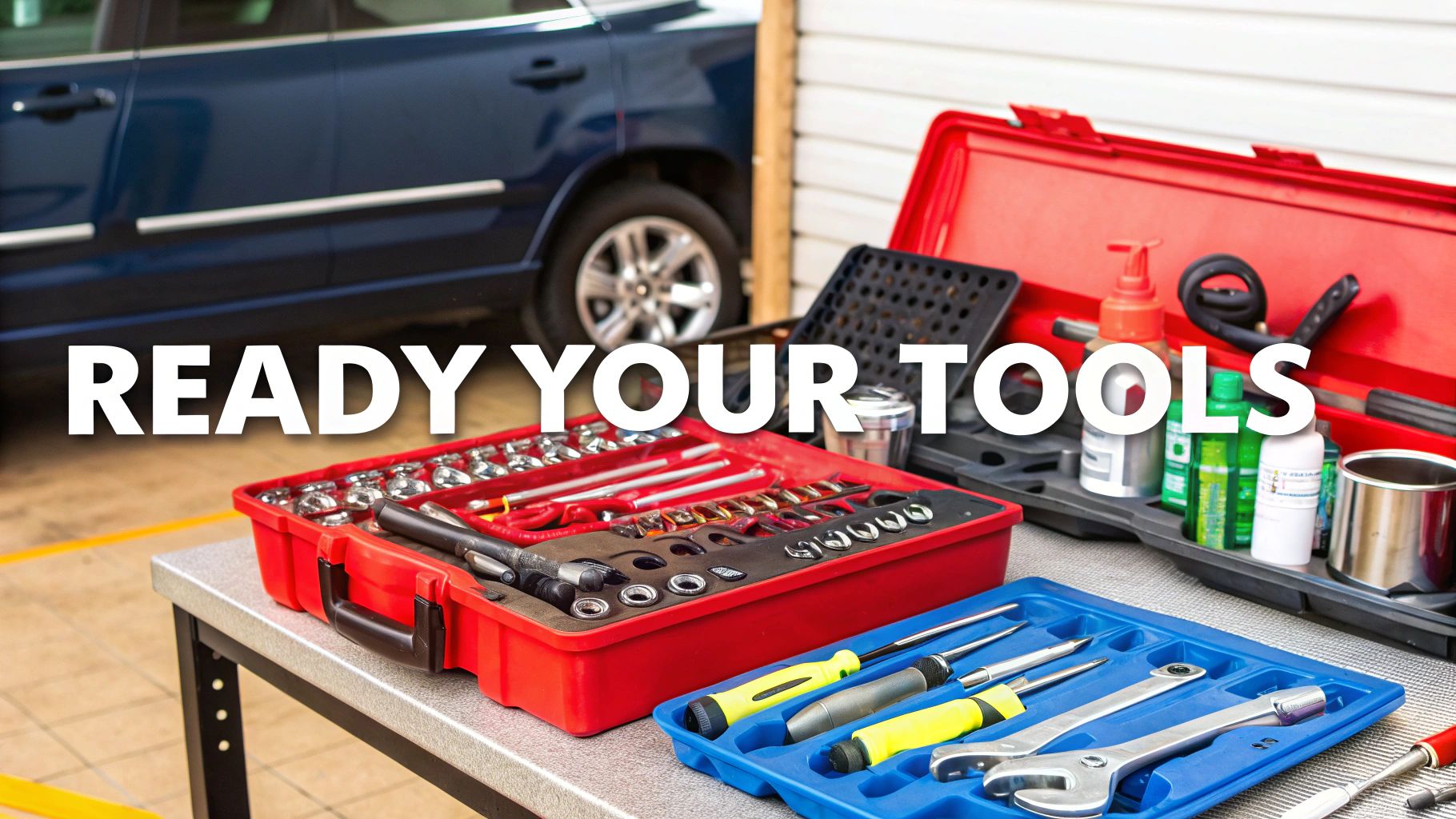 An organized set of essential hand tools for a vehicle repair laid out on a clean surface.