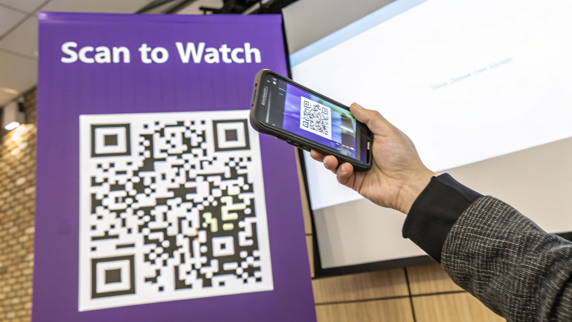 A person uses a smartphone to scan a QR code on a purple sign that reads 'Scan to Watch'.