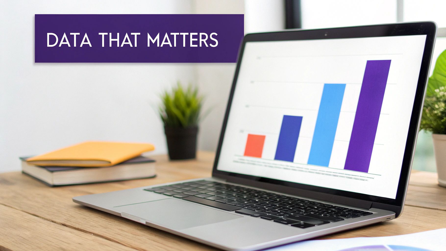 A laptop displaying a bar graph sits on a wooden desk with a 'DATA THAT MATTERS' banner.