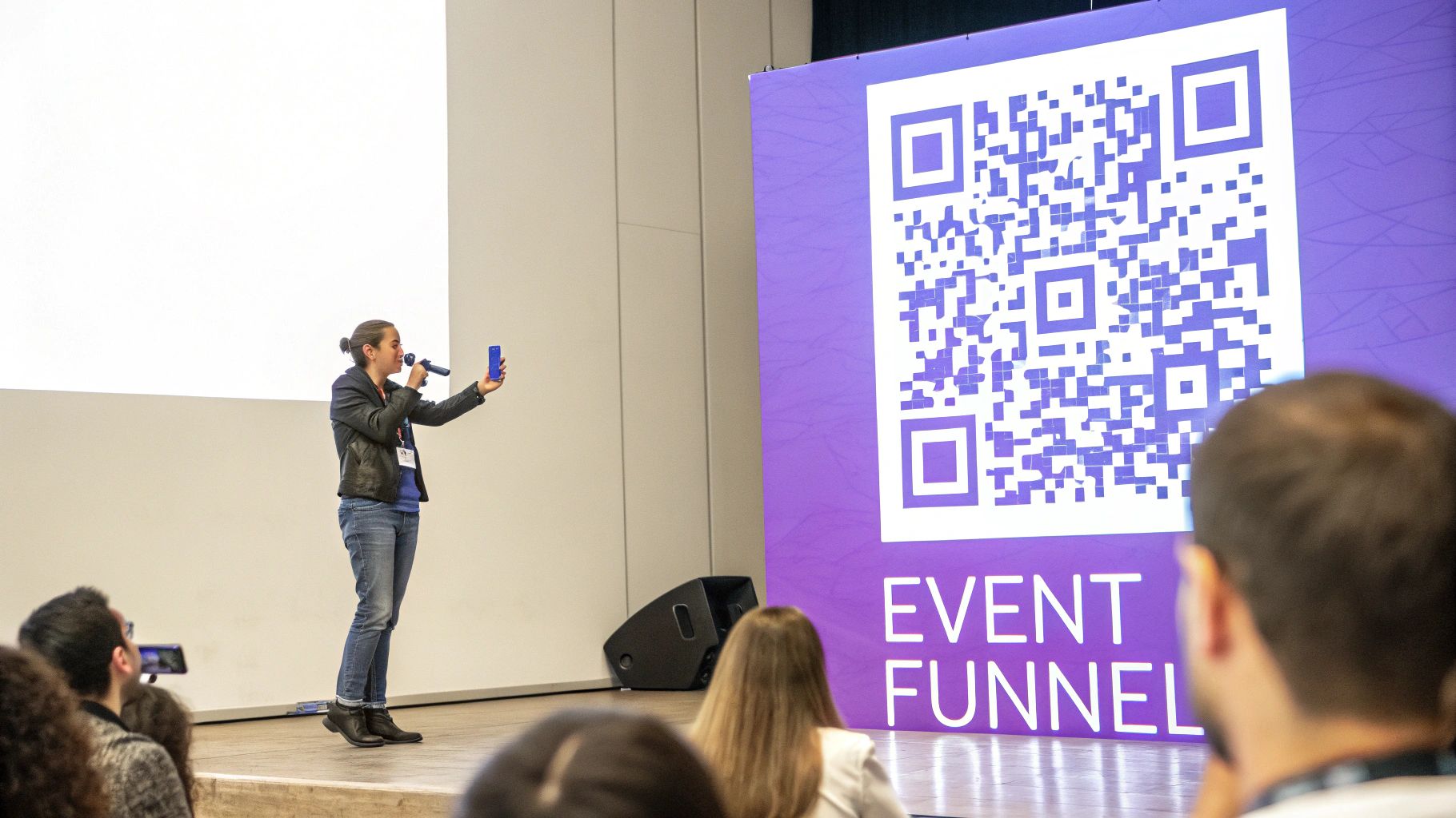 A speaker on stage holds a microphone and a phone, next to a large banner with a QR code for 'EVENT FUNNEL'.