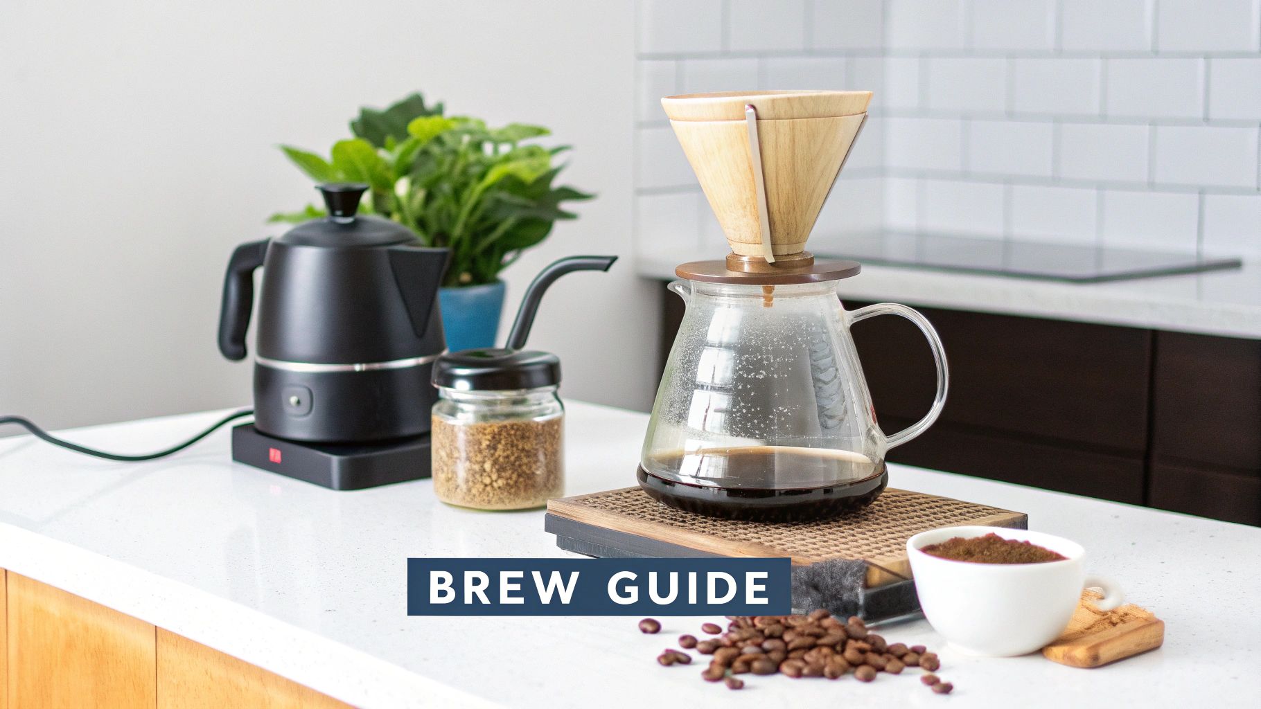 A coffee brewing setup on a white kitchen counter with a black kettle, pour-over, and coffee beans.
