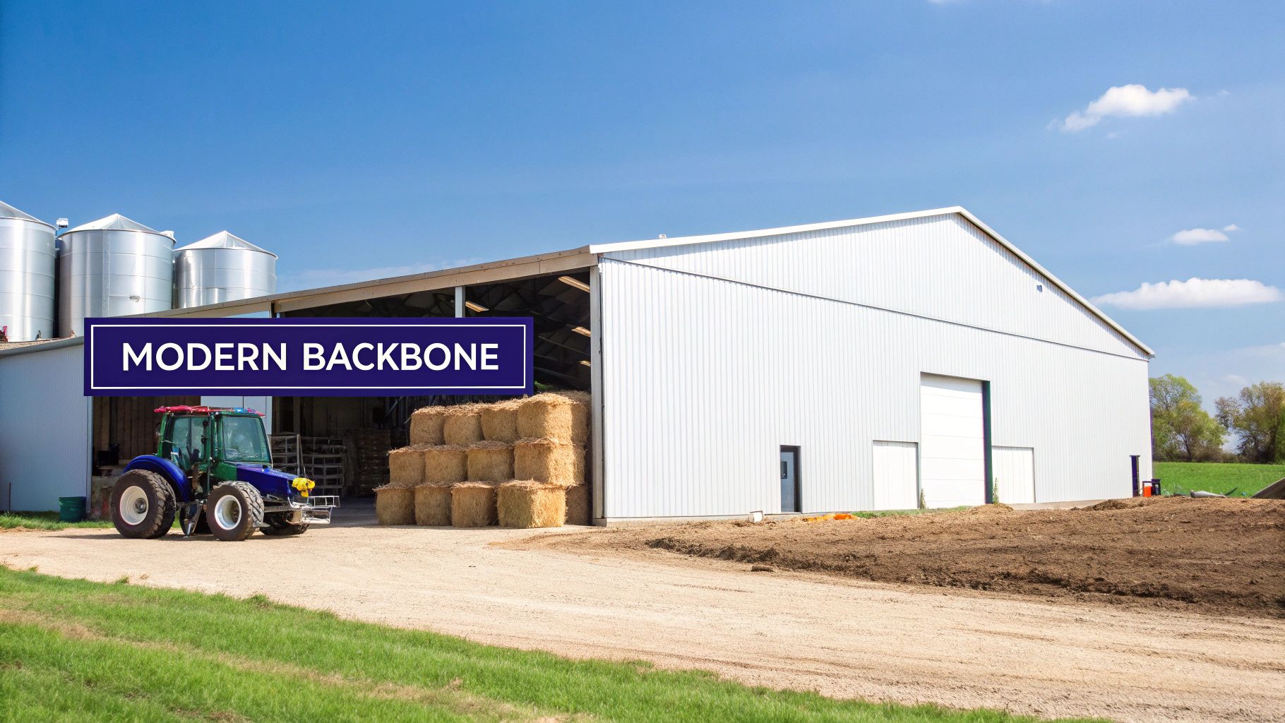 A large, modern metal agricultural building with roll-up doors, housing farm equipment under a clear sky.