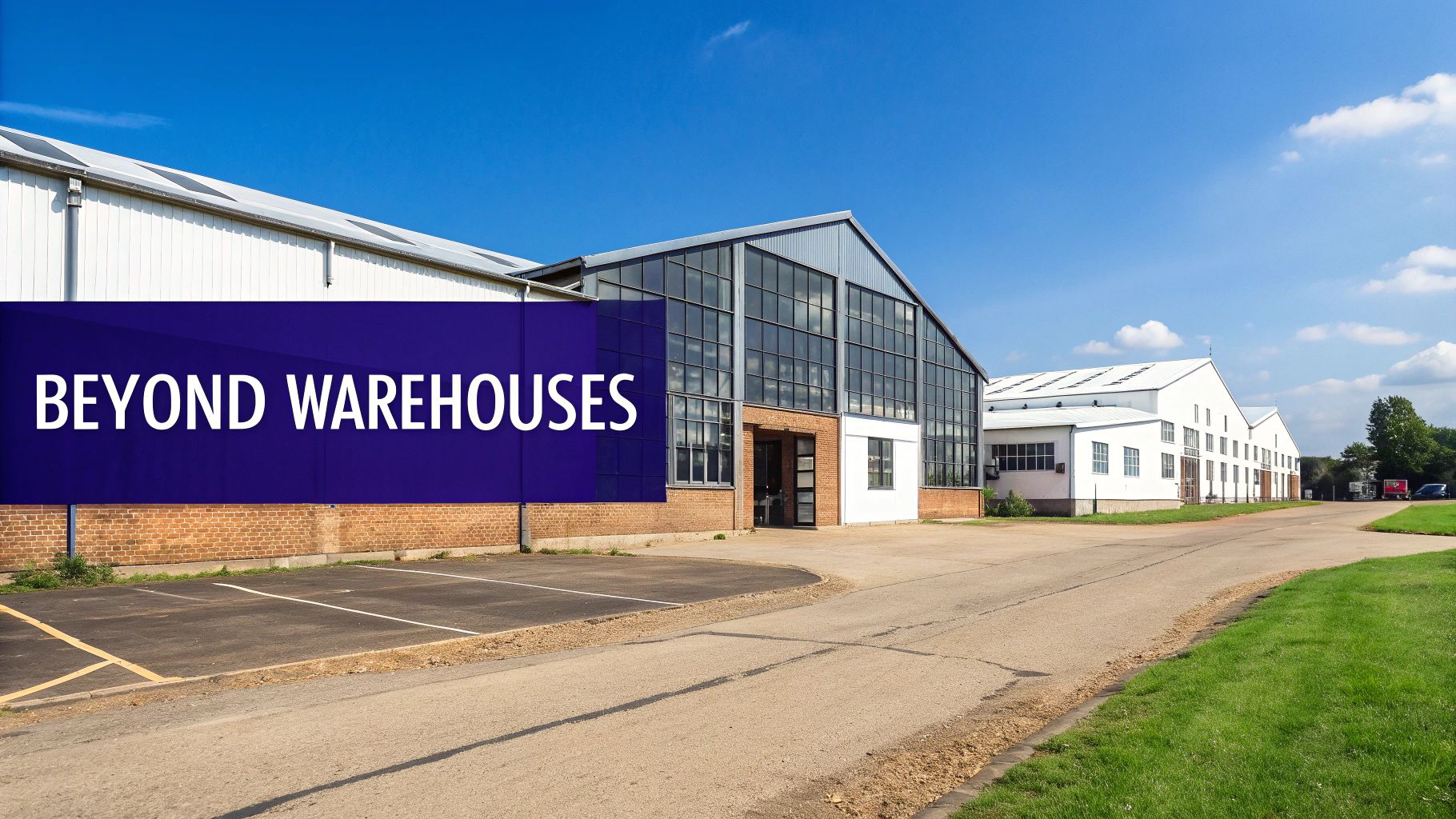 Several modern industrial buildings with clean lines and glass facades under a bright blue sky.