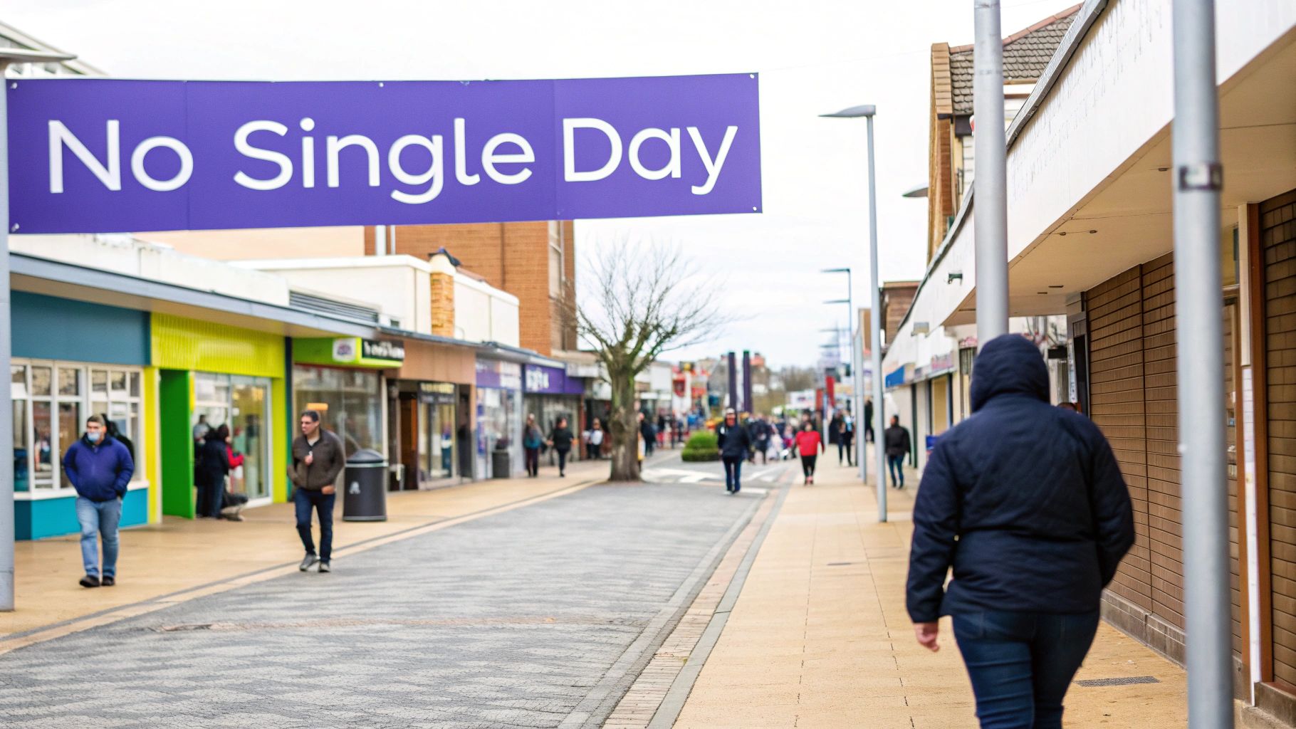 A purple banner with 'No Single Day' hangs over a pedestrian shopping street with people walking.