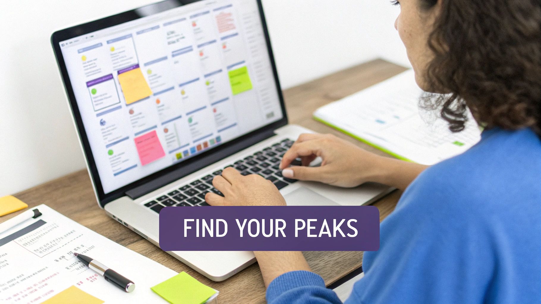 A person types on a laptop displaying a digital calendar with colorful notes, symbolizing effective time management.