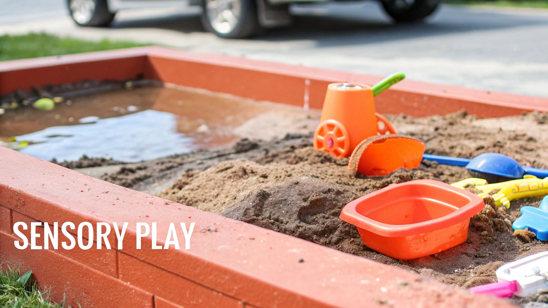 A child plays at a DIY wooden mud kitchen with sinks, utensils, and containers, demonstrating a sand and water play area.