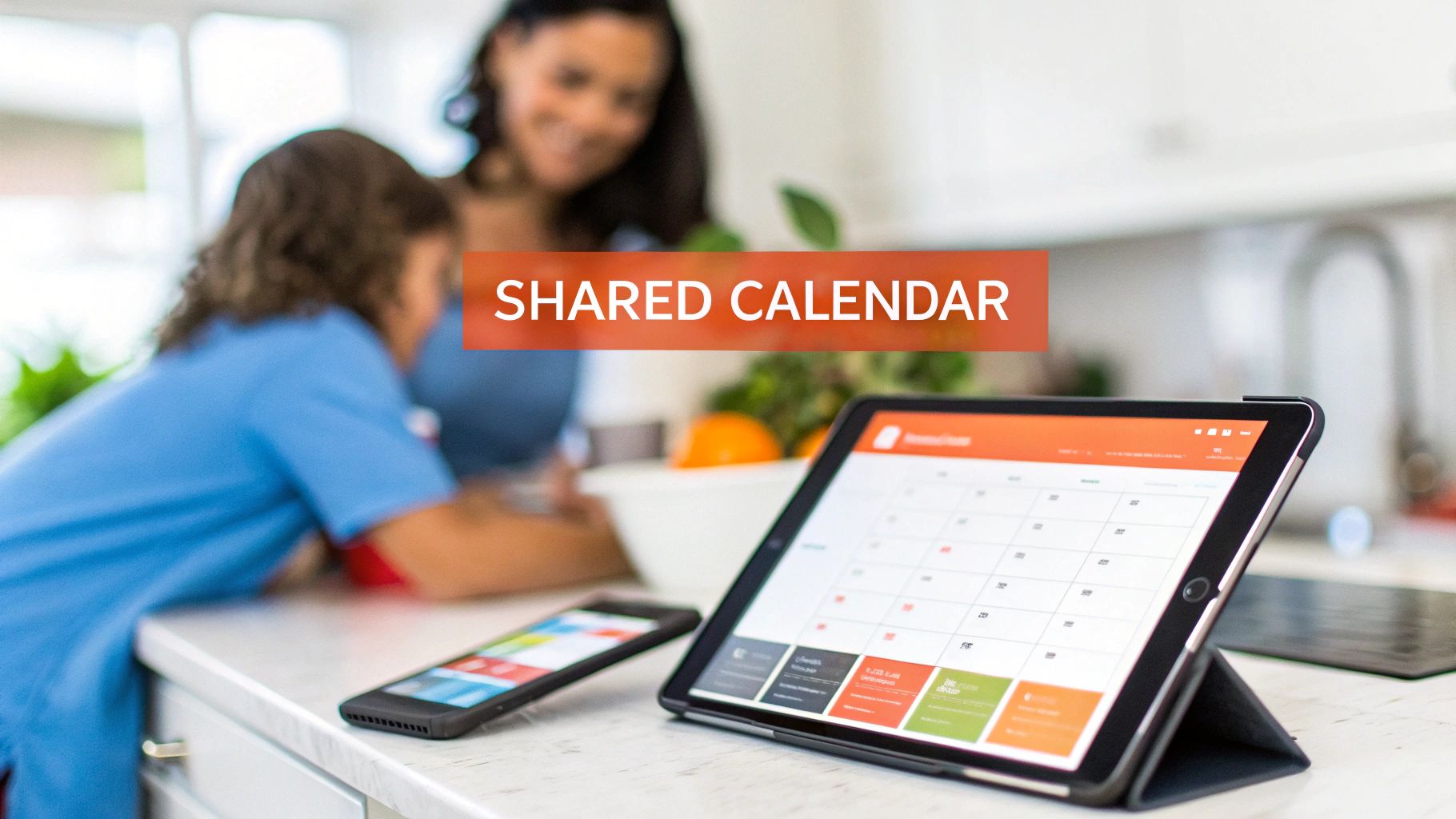 Tablet and phone displaying a shared calendar in a kitchen, with a family in the background.