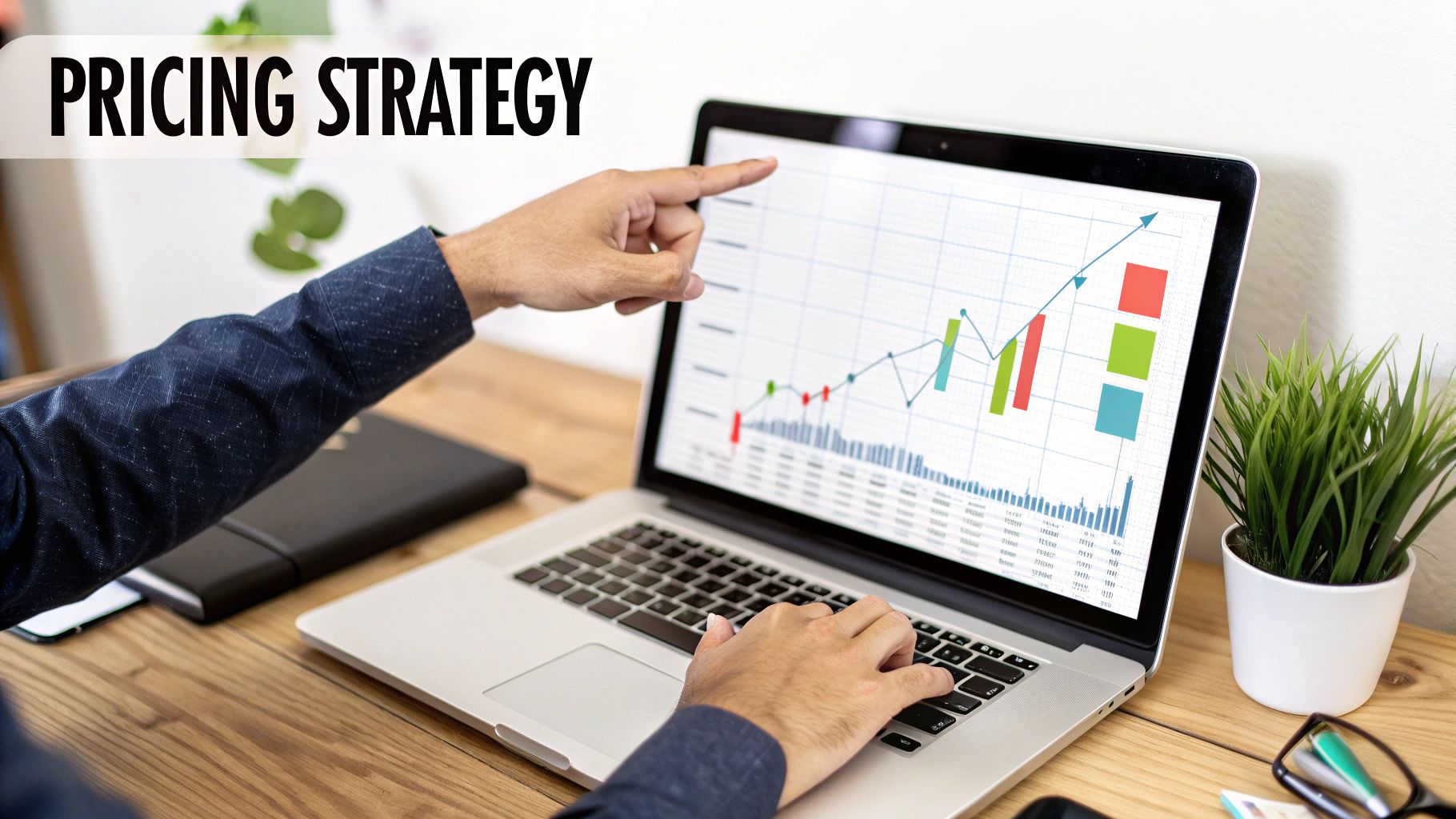 A person points at a laptop screen showing a financial graph with 'PRICING STRATEGY' text.