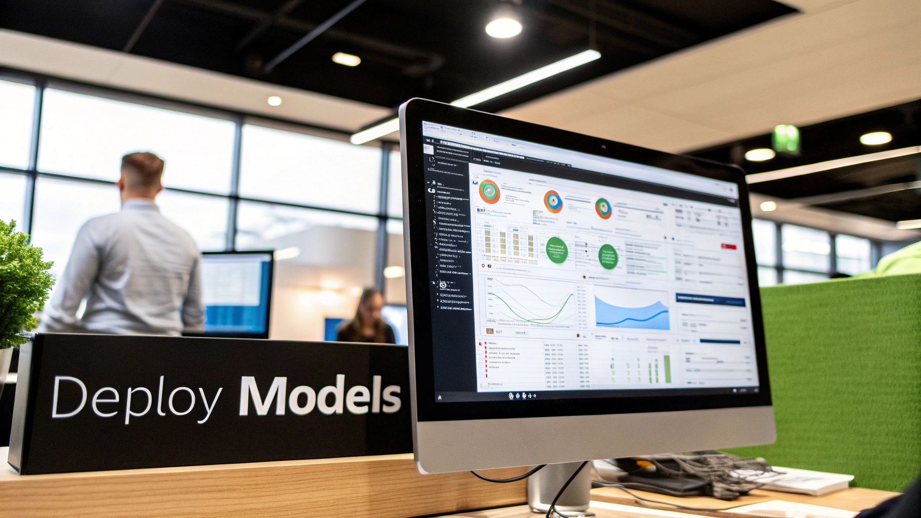 A developer manages AI model versions on a laptop in a minimalist office environment