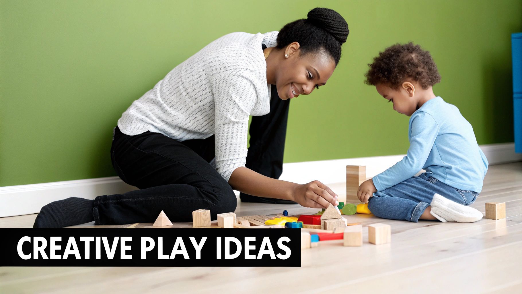 A smiling adult and a young child play with colorful building blocks on a wooden floor.