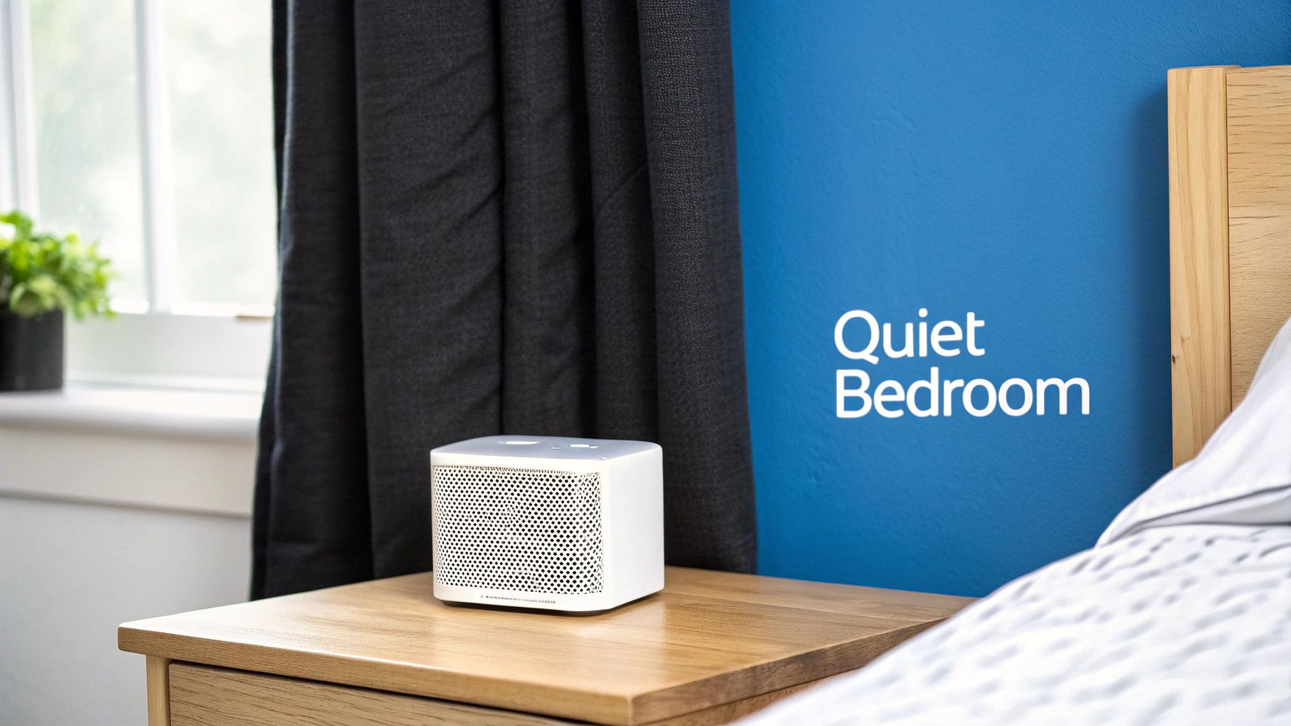 A serene bedroom with heavy blackout curtains and a white noise machine on the nightstand.
