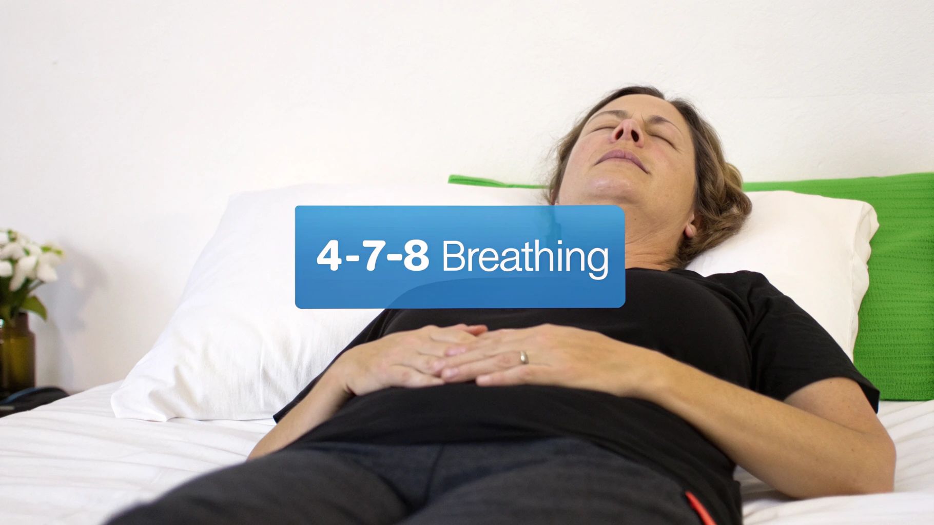 A woman lies relaxed in bed with her eyes closed, practicing 4-7-8 breathing to aid sleep.
